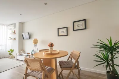 a dining room with a table and chairs at Cedofeita Bliss - 1BDR with AC in Porto