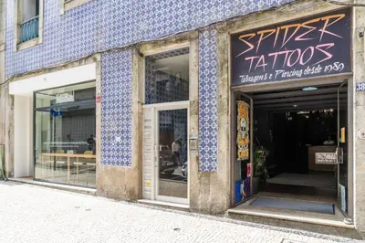 a store front with blue and white tiles on the facade at Cedofeita Bliss - 1BDR with AC in Porto