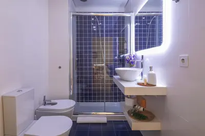 a bathroom with a toilet and a sink and a shower at Cedofeita Bliss - 1BDR with AC in Porto