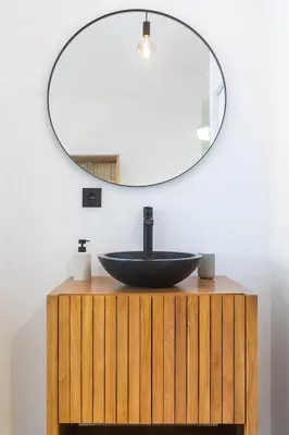a bathroom with a black sink and a mirror at Oporto Charming Studio Gaia in Vila Nova de Gaia