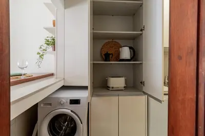 a laundry room with a washer and dryer in a kitchen at Apartment in city center in Porto