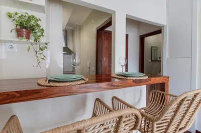 a dining room with a table with chairs and a mirror at Apartment in city center in Porto