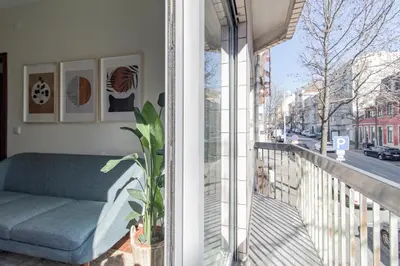 a balcony with a couch on a balcony at Apartment in city center in Porto