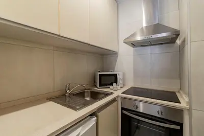 a kitchen with a sink and a microwave at Apartment in city center in Porto