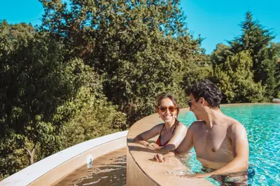 a man and a woman sitting in a swimming pool at The Lost Garden in Vila Nova de Gaia