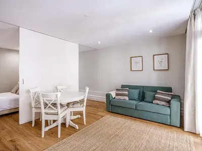 a living room with a table and a couch at Oporto View Apartments in Porto