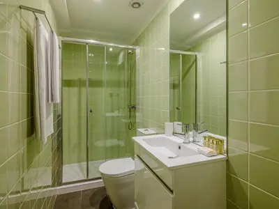 a bathroom with a toilet and a sink and a shower at Oporto View Apartments in Porto