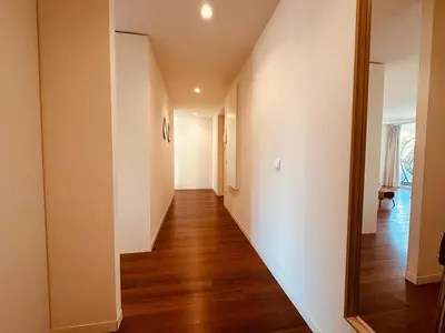 a hallway of a home with wood floors and a mirror at Bombarda H in Porto