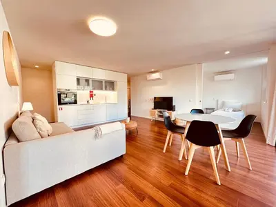 a living room with a white couch and a table at Bombarda H in Porto