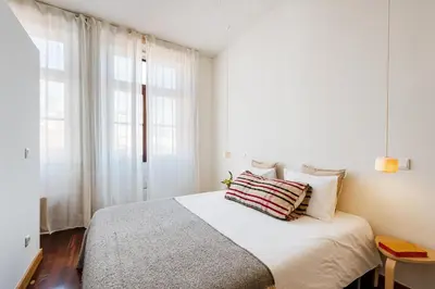 a bedroom with a bed and a large window at Hey Apartments B in Porto