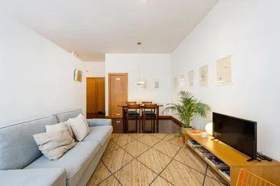 a living room with a couch and a tv at Hey Apartments B in Porto
