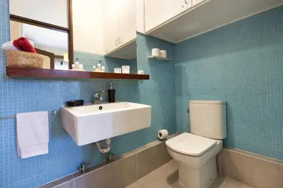a bathroom with a white sink and a toilet at LV Premier Apartments Clerigos- RE1 in Porto