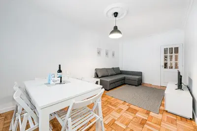 a living room with a white table and a couch at GuestReady - Hospitality Atrium - Leite Residence in Vila Nova de Gaia