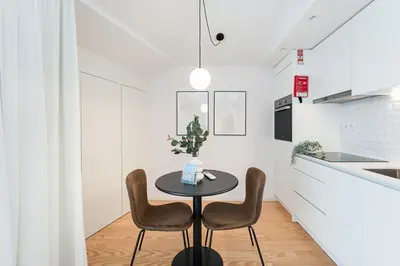 a small table in a kitchen with two chairs at GuestReady - Porto's Modern Comfort in Porto