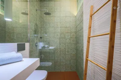 a bathroom with a shower and a toilet and a sink at ApartmentsPorto - Apartamento Belas Artes in Porto