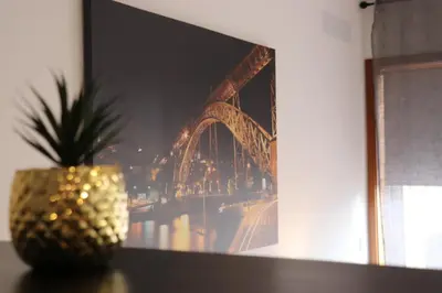 a pineapple sitting on a table next to a picture of a bridge at Estudio Metro heroismo in Porto