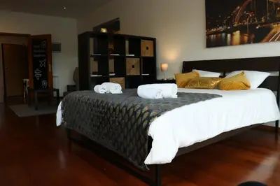 a bedroom with a large bed with towels on it at Estudio Metro heroismo in Porto