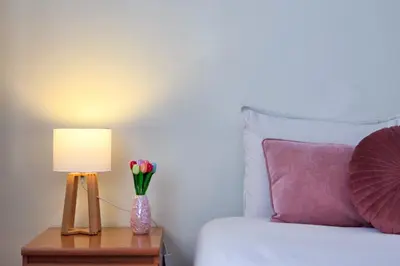 a white bedroom with a bed and a window at Patio House - 2 Bedroom flat - Pet Friendly in Porto