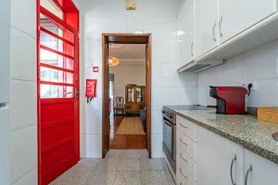 a dining room with a table and chairs and a television at Patio House - 2 Bedroom flat - Pet Friendly in Porto