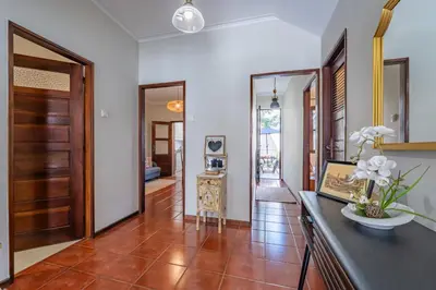 a bedroom with a bed with a mirror and a window at Patio House - 2 Bedroom flat - Pet Friendly in Porto