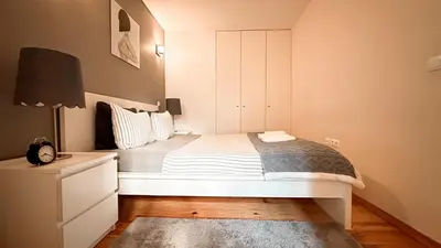 a bedroom with a large white bed with a night stand at Almada Apartments 468 in Porto
