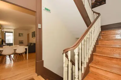 a staircase leading to a living room with a table at Almada Apartments 468 in Porto
