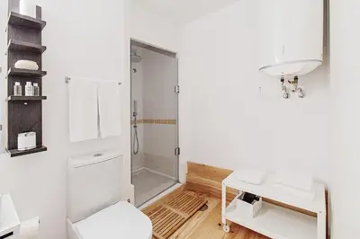 a white bathroom with a shower and a sink at Almada Apartments 468 in Porto