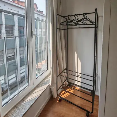 a iron bed in a room next to a window at Grandma aparts in Porto
