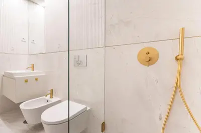 a bathroom with a toilet and a glass shower at ApartmentsPorto - Almada 318 in Porto