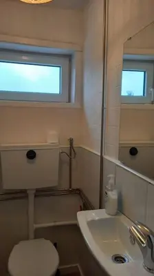 a bathroom with a toilet and a sink and a mirror at Lulapartment in Porto
