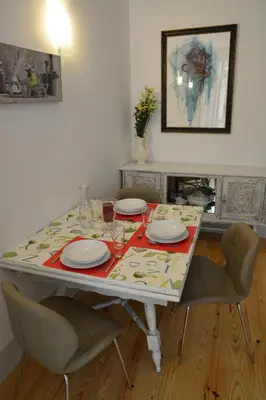 a dining room table with plates and glasses on it at Oporto Almada 329 in Porto