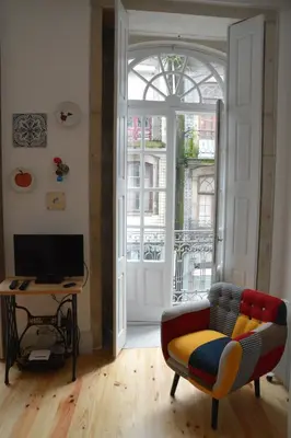 a living room with a couch and a table and a window at Oporto Almada 329 in Porto