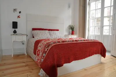 a white bedroom with a bed with a red blanket at Oporto Almada 329 in Porto