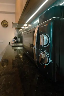 a kitchen with a microwave with a picture on it at The Cale - Antero de Quental - 12 in Porto
