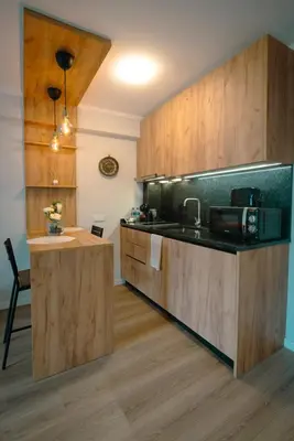 a kitchen with wooden cabinets and a counter top at The Cale - Antero de Quental - 21 in Porto