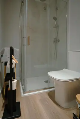 a bathroom with a shower and a white tub at The Cale - Antero de Quental - 21 in Porto
