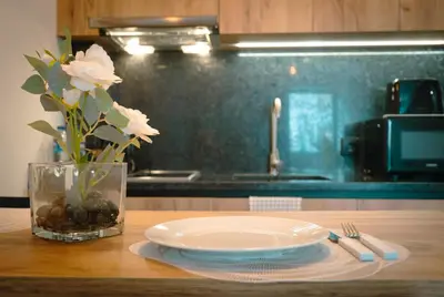 a table with a plate and a vase with white flowers at The Cale - Antero de Quental 31 in Porto