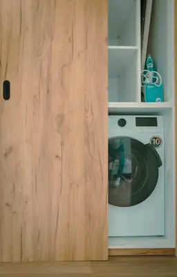 a kitchen with a microwave and a wooden door at The Cale - Antero de Quental 32 in Porto