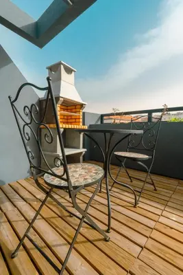 a balcony with a table and chairs on a deck at The Cale - Antero de Quental 32 in Porto