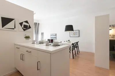 a kitchen with white cabinets and a white counter top at BmyGuest - Santa Catarina's Loft in Porto