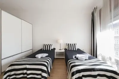 two beds in a small room with black and white stripes at BmyGuest - Santa Catarina's Loft in Porto