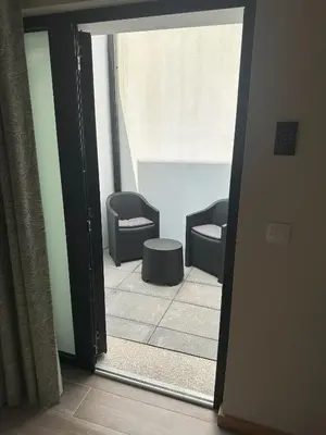 a green tiled bathroom with a shower and a toilet at Oporto Station Hostel & Rooms in Porto
