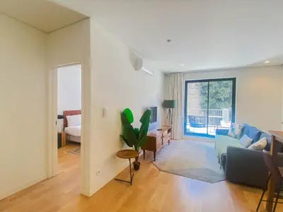 a living room with a couch and a table at Paraíso E in Porto