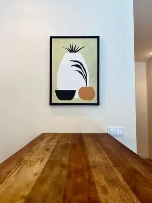 a painting on a white wall with a wooden floor at Paraíso E in Porto