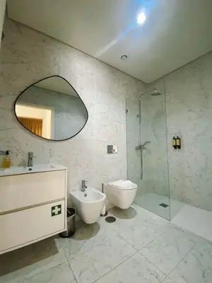 a bathroom with a sink and a toilet and a shower at Paraíso E in Porto