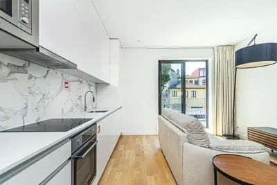 a kitchen with a couch and a table at Paraíso 57 D in Porto
