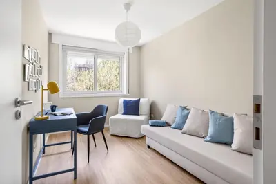 a living room with a white couch and a table at Wonderful 2BR Apartment in Boavista by LovelyStay in Porto