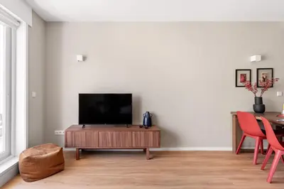 a living room with a television on a wooden table at Wonderful 2BR Apartment in Boavista by LovelyStay in Porto