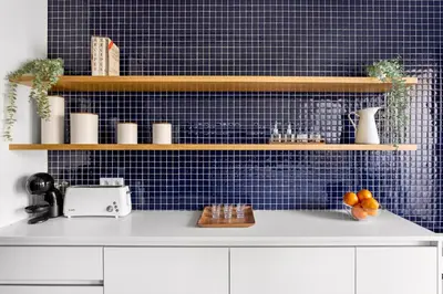 a kitchen with blue tiled walls and wooden shelves at Wonderful 2BR Apartment in Boavista by LovelyStay in Porto