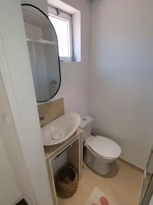 a bathroom with a toilet and a sink and a mirror at Casa Cadu - Porto in Porto
